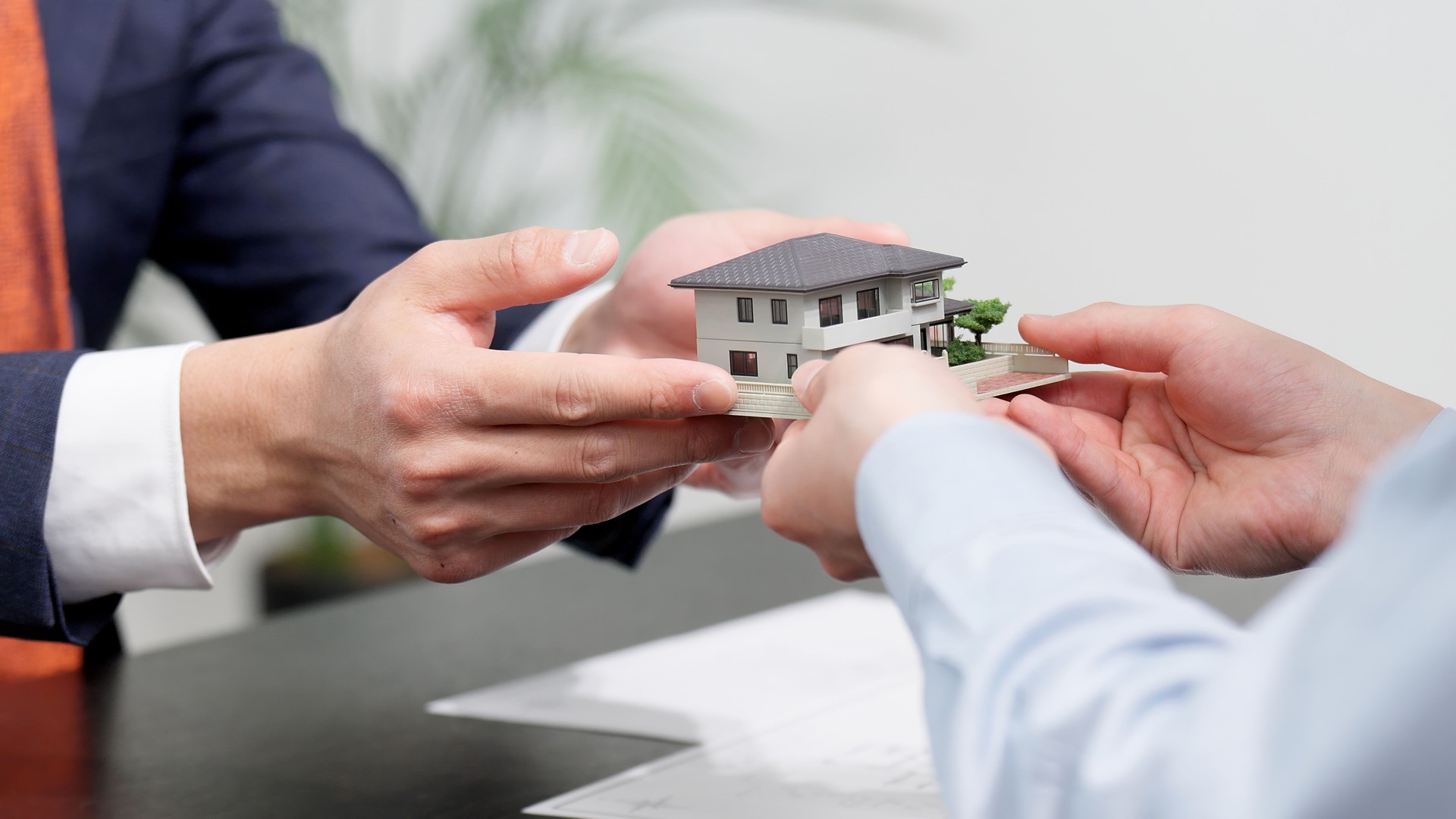 Hands of a businessman selling real estate